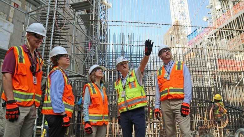 A team of NRC officials look up at Vogtle's third reactor during its construction.