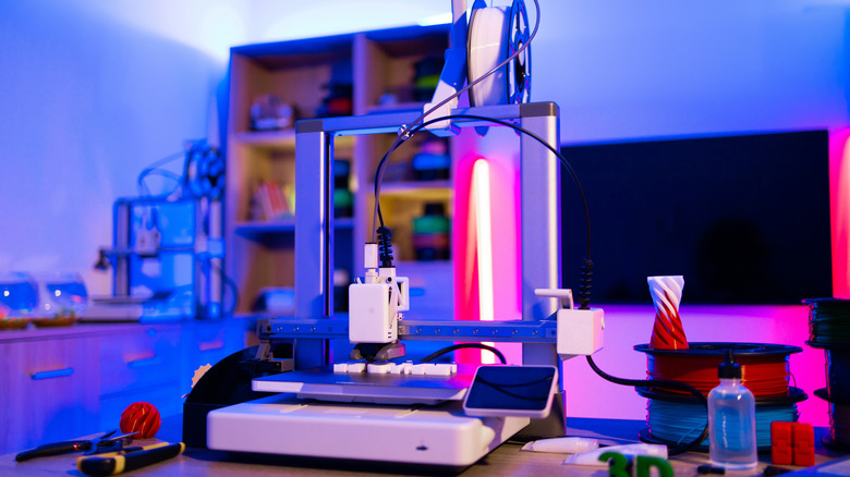 A 3D printer working on a living room table.