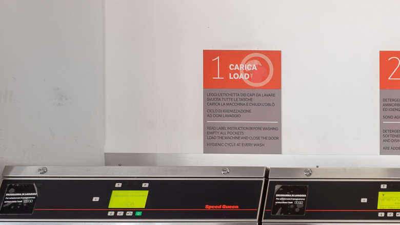 Speed Queen washers and dryers are lined up against a wall.