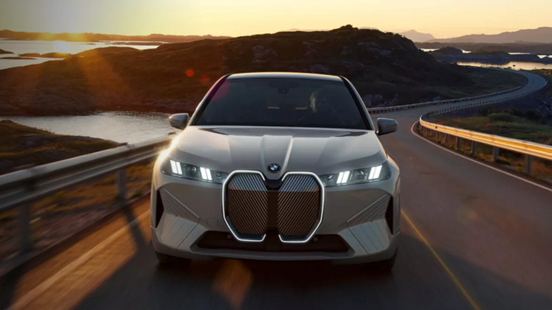 A BMW electric car shown racing towards the camera on a winding road