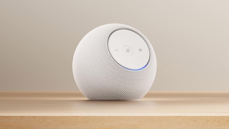 A Glacial White Amazon Echo Dot Max on a wooden surface