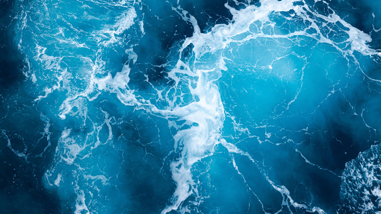 blue ocean waves crashing against each other