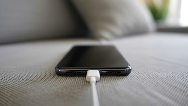 A phone connected to a charging cable.