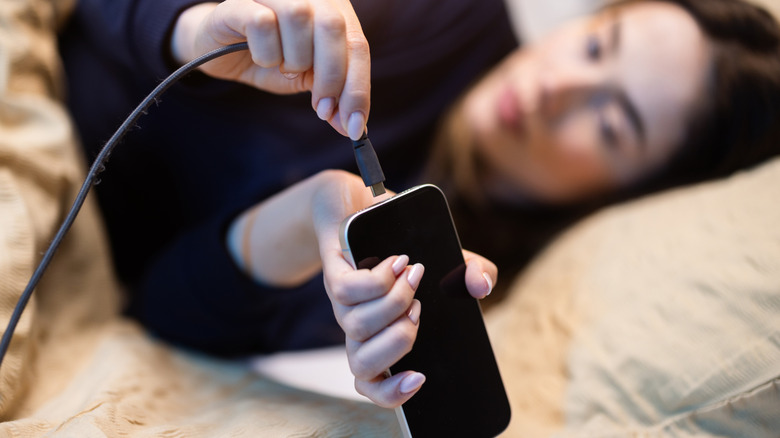 Using a phone in bed while the battery is charging.