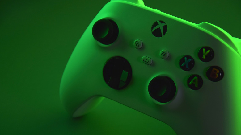 A green Xbox controller on a green background