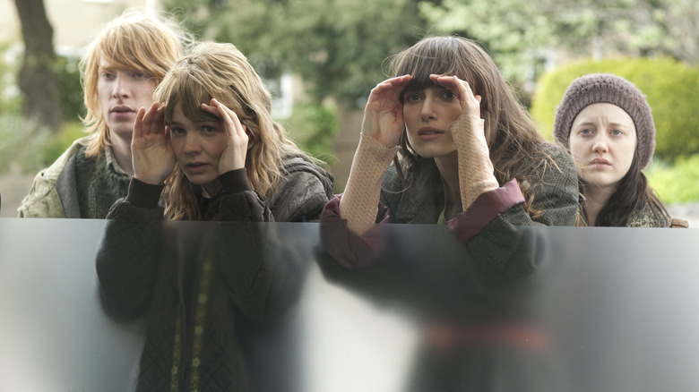 Kathy and Ruth looking through a glass window