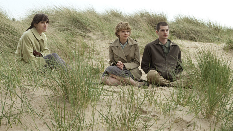 Ruth, Kathy, and Tommy sitting in the sand on the beach