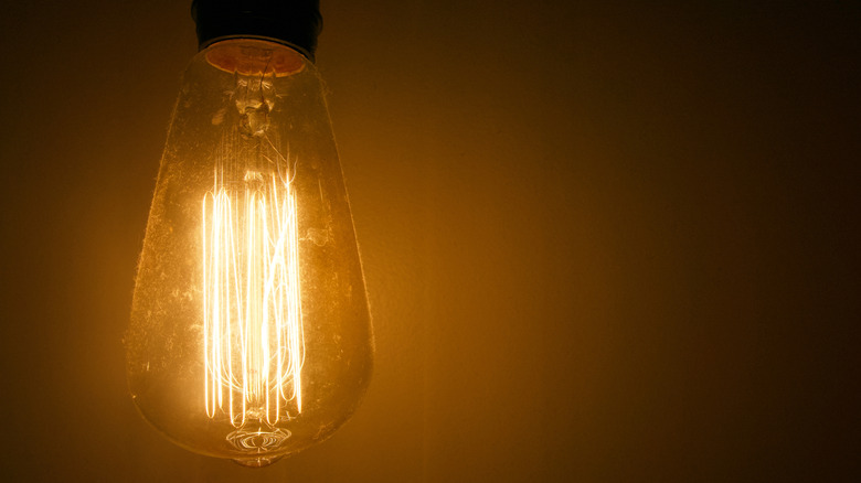 An incandescent light bulb with orange glow