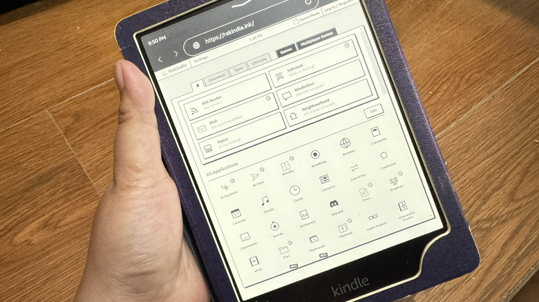 Hand holds a Kindle showing ReKindle website