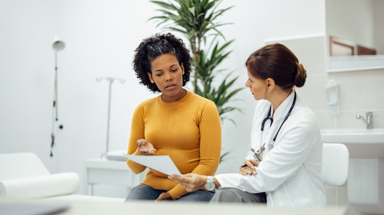 a woman visits a female doctor and they discuss a medical test