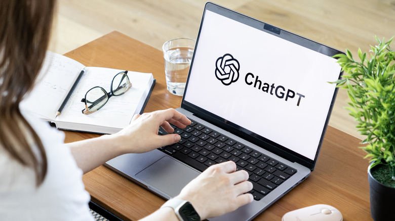 A woman using ChatGPT on a laptop.