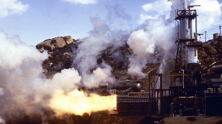 A rocket test is conducted at the Santa Susana Field Laboratory, emitting clouds of smoke.