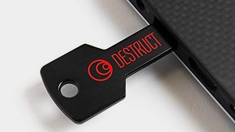 Military-grade DESTRUCT USB gadget plugged into laptop.