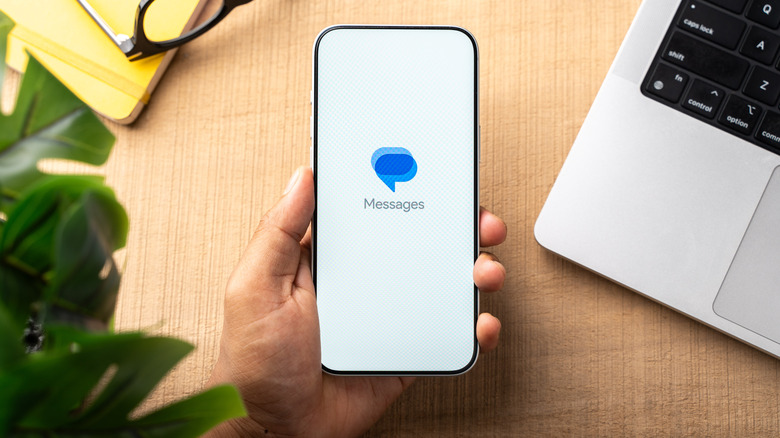 Google Messages logo on smartphone screen from a top-down view.