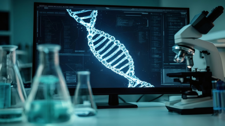 DNA strand on a monitor surrounded by science equipment
