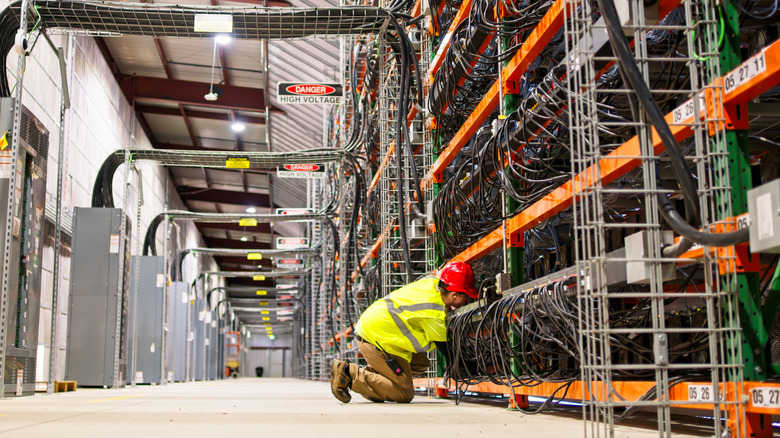 A technician working on equipment at a data center
