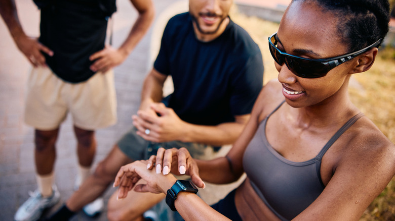 A group of people using wearable health trackers