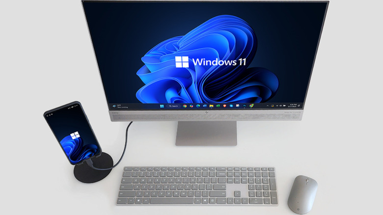 A NexPhone connected to a computer monitor on a desktop