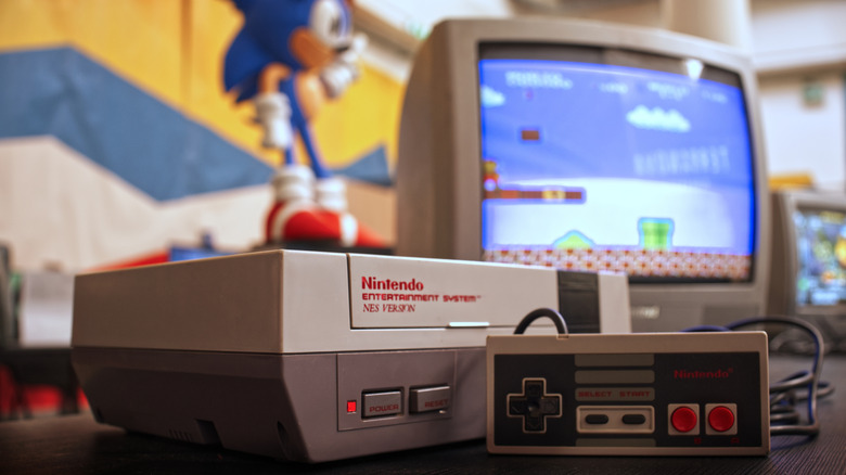 A Nintendo Entertainment System connected to a retro TV with a Sonic figurine in the background