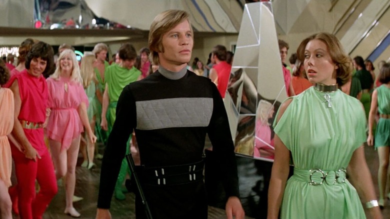 Logan 5 (Michael York) and Jessica 6 (Jenny Agutter) standing next to each other in 