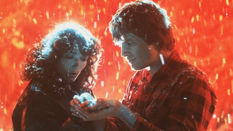 Jenny and Starman looking at an energy ball in the latter's hand