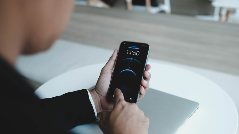 A person unlocking an iPhone.