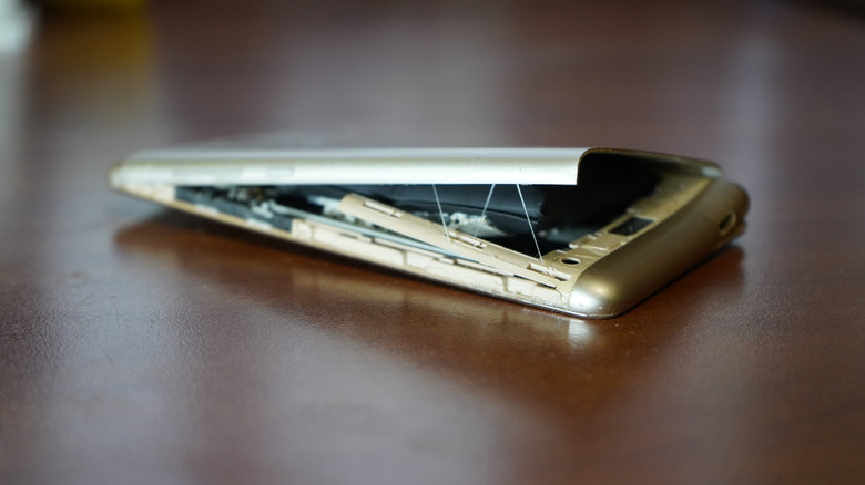 smartphone with a damaged and swollen battery