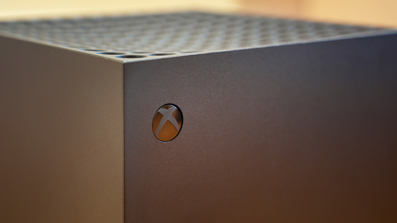 A closeup of the Xbox logo on a black Xbox Series X
