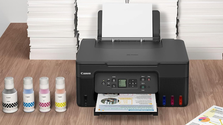 The Canon MegaTank G3270 set up in front of stacks of paper