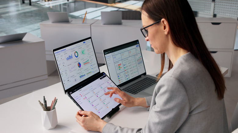 A woman using multiple devices to look at data