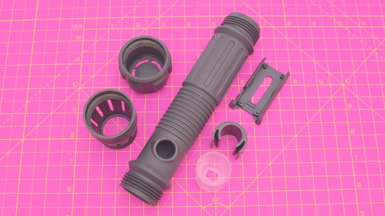Adafruit 3d printed lightsaber parts on pink cutting mat