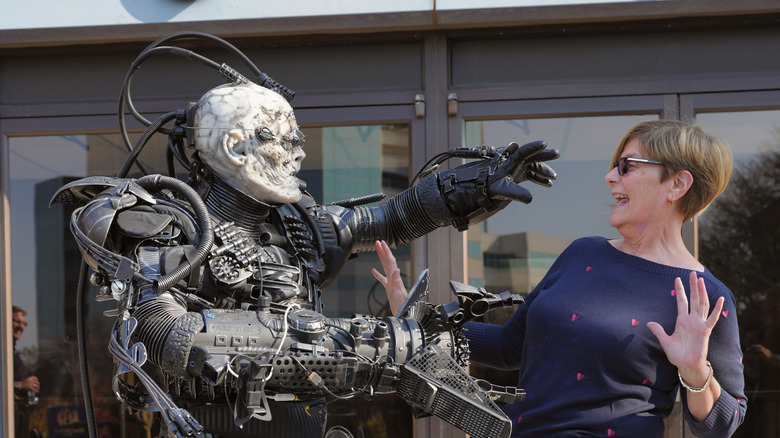 An image of a cosplayer dressed as a borg pretending to menace a woman
