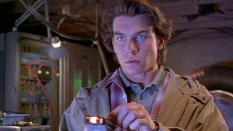 The character of Quinn Mallory looking past the camera with a focused expression on his face.