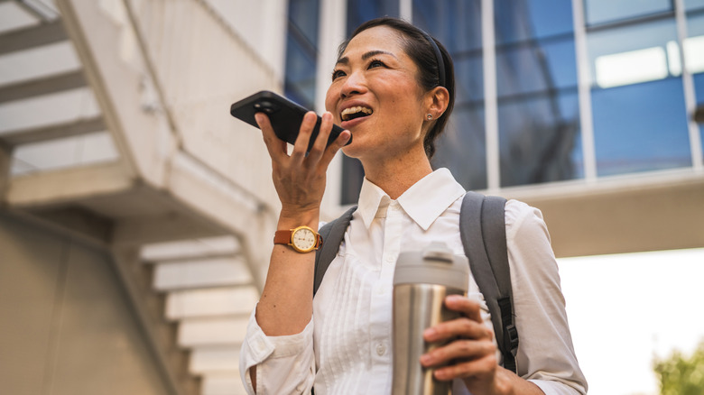 Woman using the speakerphone function on her smartphone