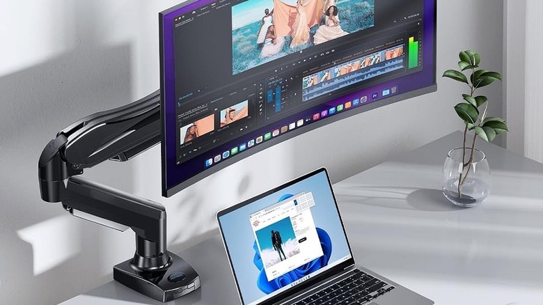 Huanuo monitor mounting arm in use to suspend display.