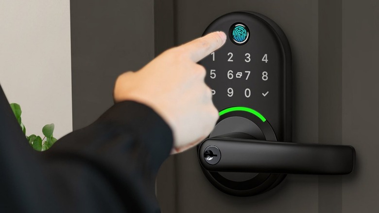 A person touching the fingerprint sensor on the Yamiry Smart Door Lock