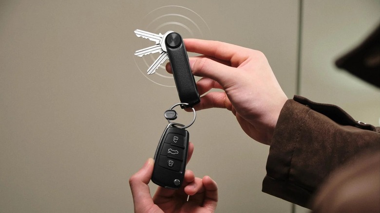 Hand holding Orbitkey Key Organizer Tracker