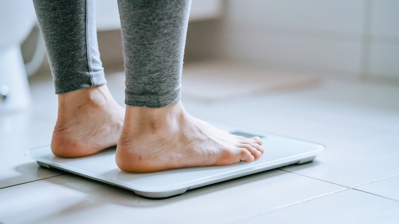 A photo of a person standing on a bathroom scale