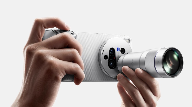 A person holding the Vivo X300 Ultra with its telephoto extender kit