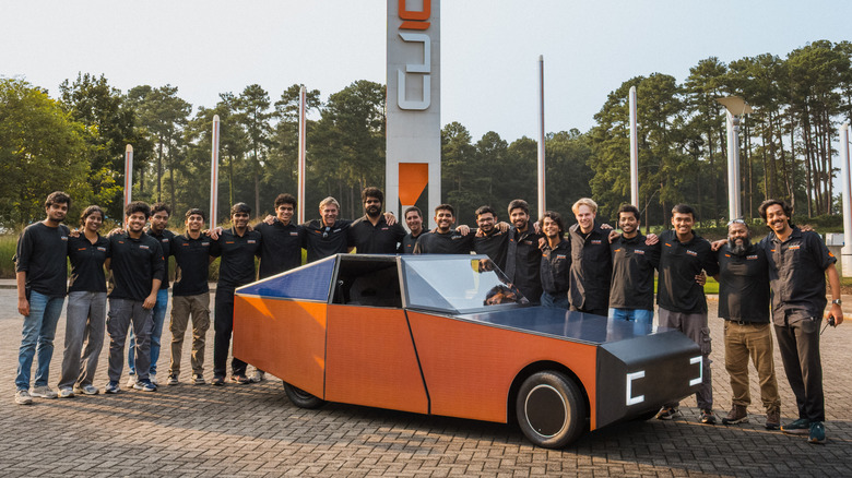 Clemson automotive engineering graduate students stand next to the Deep Orange 17 solar car prototype