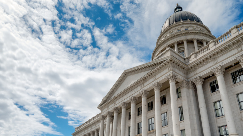 Utah state capital building set against a blue sky with clouds