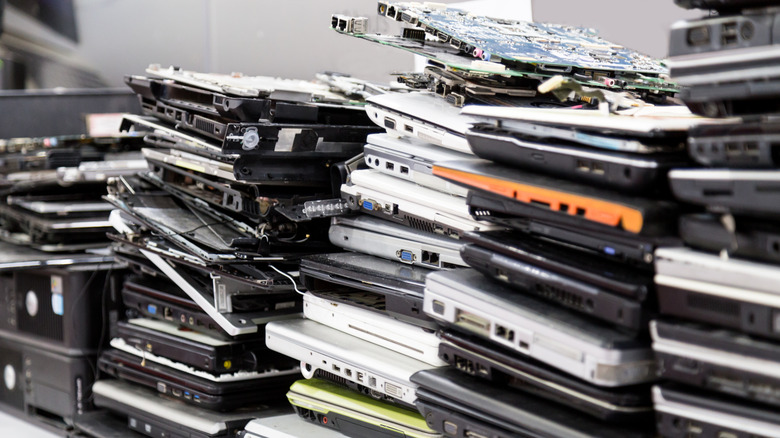 Piles of old and broken laptops.