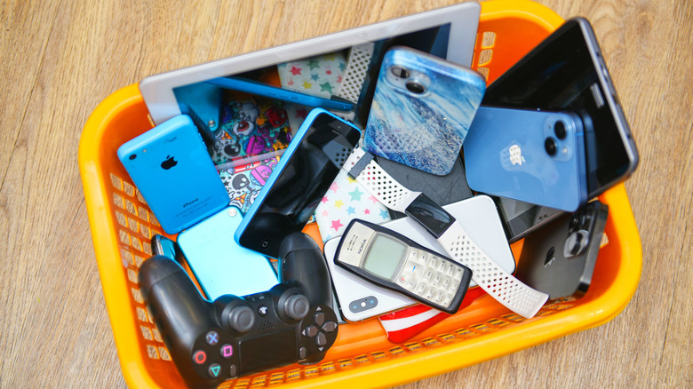 A bunch of electronics inside an orange bin.