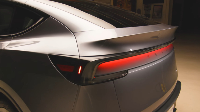 A side back view of the Tesla Model Y Juniper's red reflective tail light