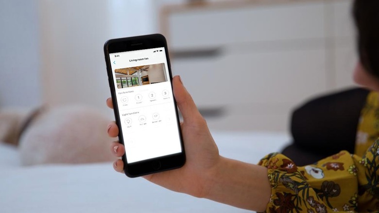 Hand holding phone showing Bond Home app