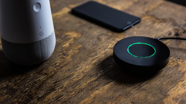 Bond Bridge on table with Google smart speaker and phone