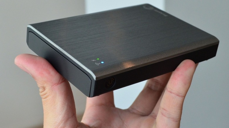 Image of a person holding up a model of Internet-in-a-box.