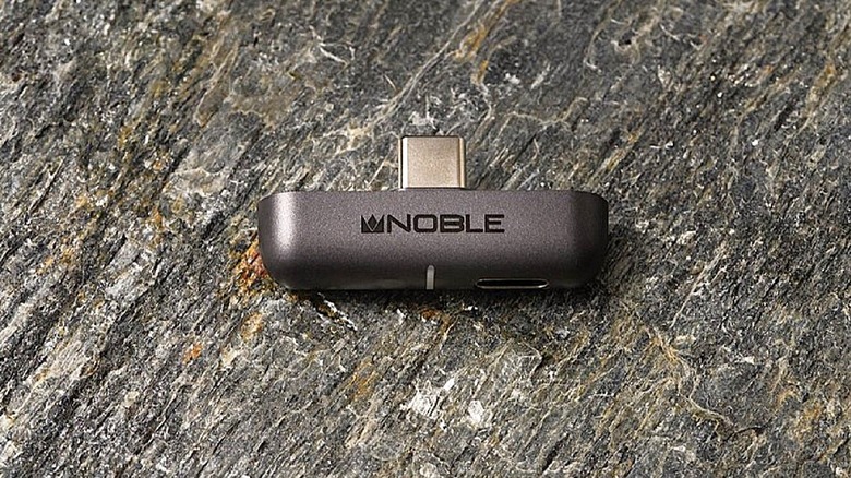 Noble Sceptre Bluetooth audio dongle on stone surface.