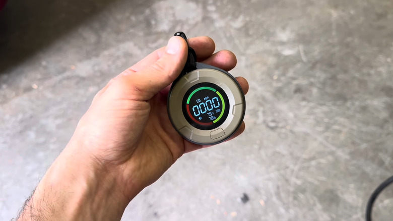 A person's hand holding the Lunarlipes portable carbon monoxide detector