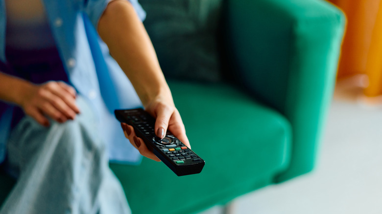 Hand holding TV remote